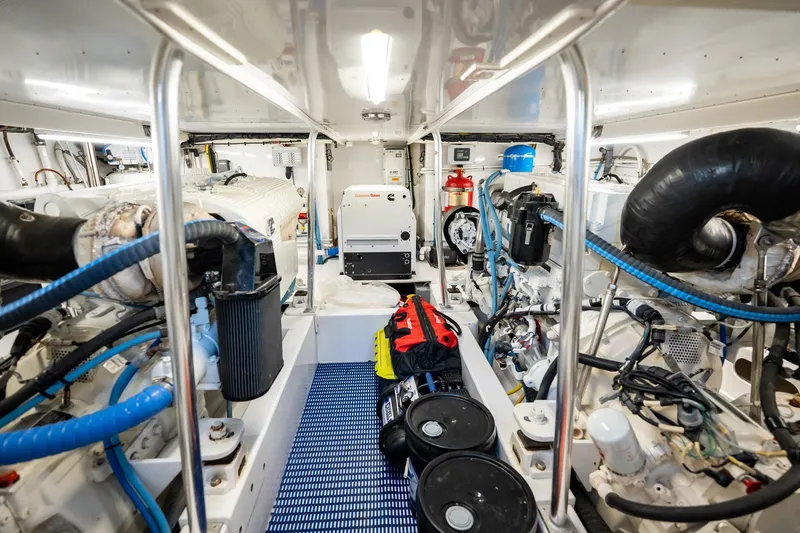Slide: The Image of Engine room of 1983 Rybovich 55 Convertible yacht, showcasing mechanical components and equipment. - 96