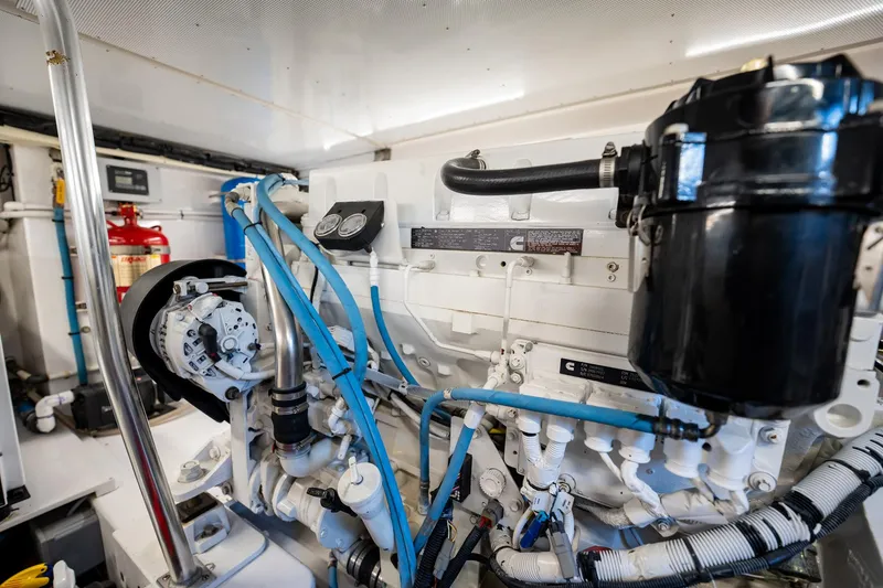 Slide: The Image of Engine room of 1983 Rybovich 55 Convertible yacht, showcasing detailed machinery and components. - 99