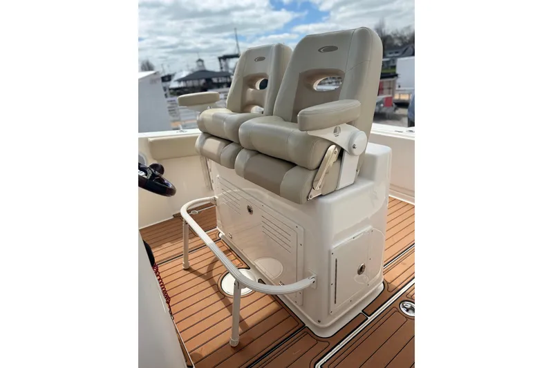 Slide: The Image of 2016 Cobia 277 Center Console boat seats on teak deck, showcasing luxury and comfort. - 10