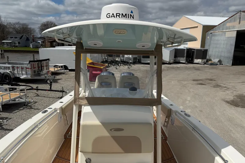 Slide: The Image of 2016 Cobia 277 Center Console boat with Garmin equipment, docked near trailers. - 12
