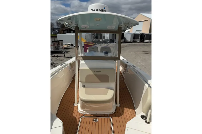 Slide: The Image of 2016 Cobia 277 Center Console boat with Garmin equipment, featuring a sleek deck design. - 13