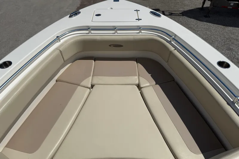 Slide: The Image of 2016 Cobia 277 Center Console boat with beige cushioned seating area. - 19
