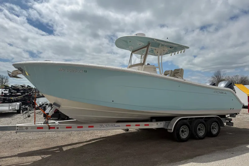 Slide: The Image of 2016 Cobia 277 Center Console boat on trailer under cloudy sky. - 2