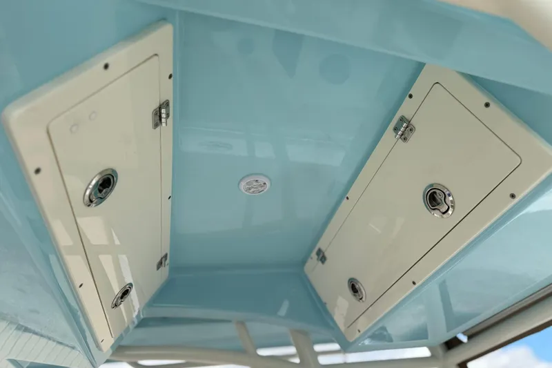 Slide: The Image of 2016 Cobia 277 Center Console boat storage compartments with sleek blue interior design. - 26