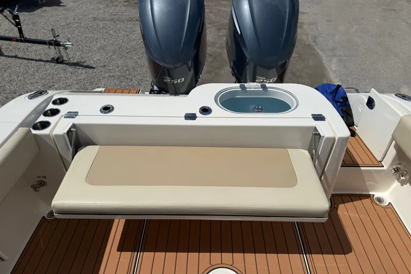 Slide: The Image of 2016 Cobia 277 Center Console boat with twin engines and cushioned seating. - 29