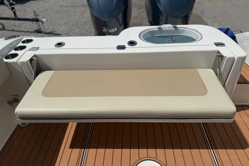 Slide: The Image of 2016 Cobia 277 Center Console boat with foldable bench seat and teak deck. - 30