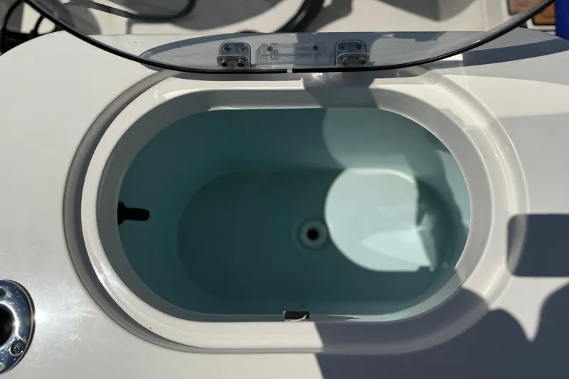 Slide: The Image of Livewell on 2016 Cobia 277 Center Console boat, open lid, sunlight reflection. - 32