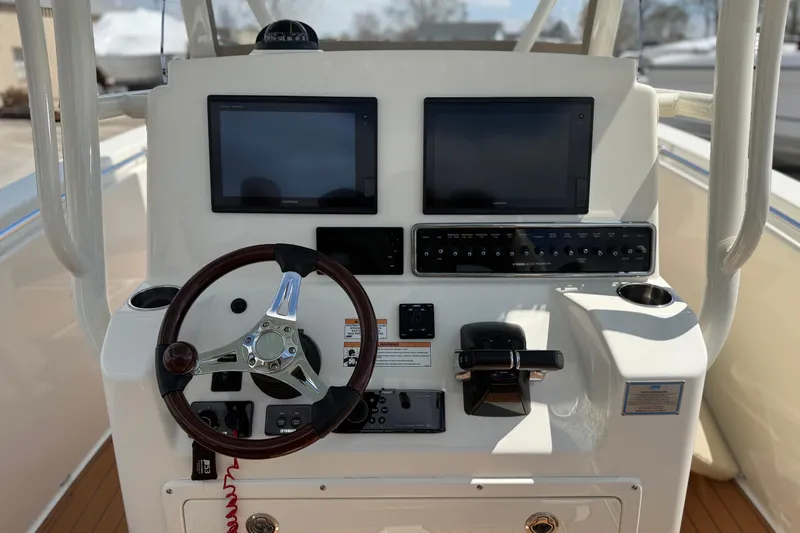 Slide: The Image of 2016 Cobia 277 Center Console helm with dual displays and steering wheel. - 4