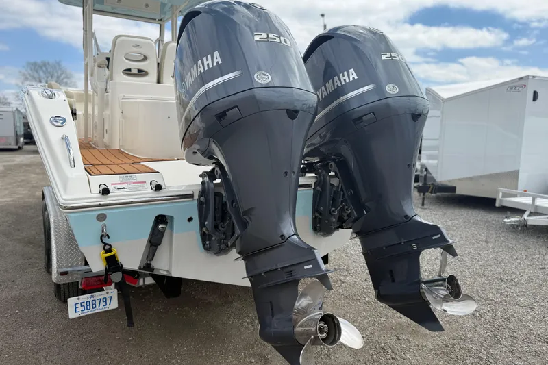 Slide: The Image of 2016 Cobia 277 Center Console with dual Yamaha 250 engines, parked on a trailer. - 40