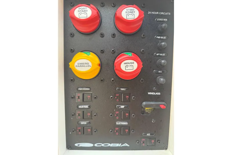 Slide: The Image of Control panel of a 2016 Cobia 277 Center Console boat with labeled switches and dials. - 41