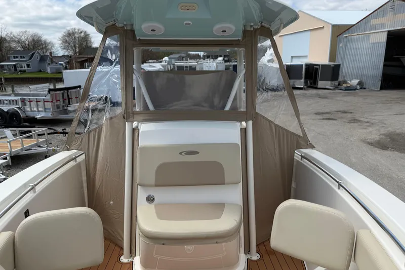 Slide: The Image of 2016 Cobia 277 Center Console boat interior with seating and clear enclosure. - 43
