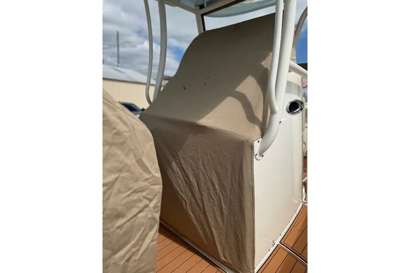 Slide: The Image of 2016 Cobia 277 Center Console with protective cover on deck. - 46