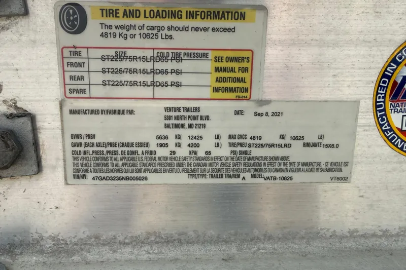 Slide: The Image of Tire and loading information label on a 2016 Cobia 277 Center Console boat trailer. - 52