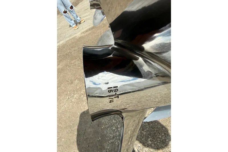 Slide: The Image of Close-up of a shiny boat propeller with engraved specifications, Cobia 277 Center Console 2016. - 58