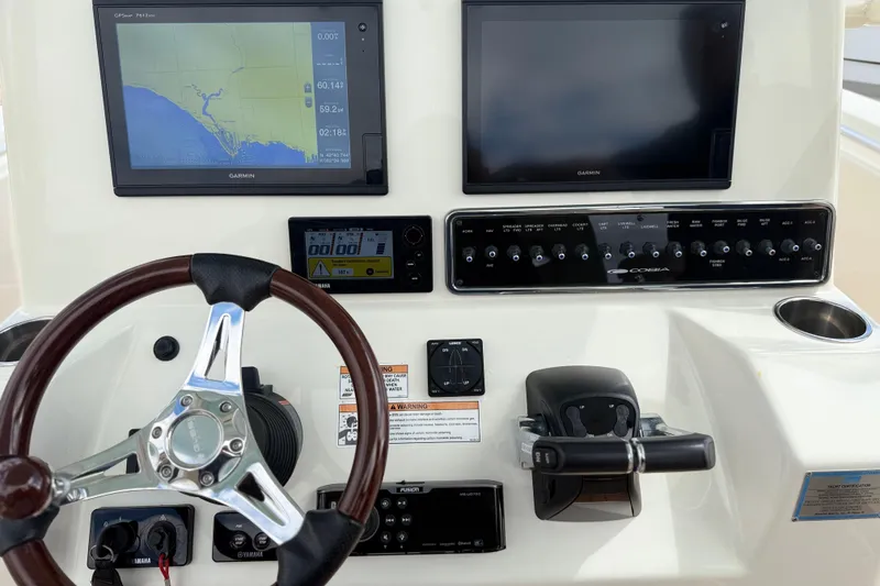 Slide: The Image of Steering console of 2016 Cobia 277 Center Console with Garmin displays and controls. - 7