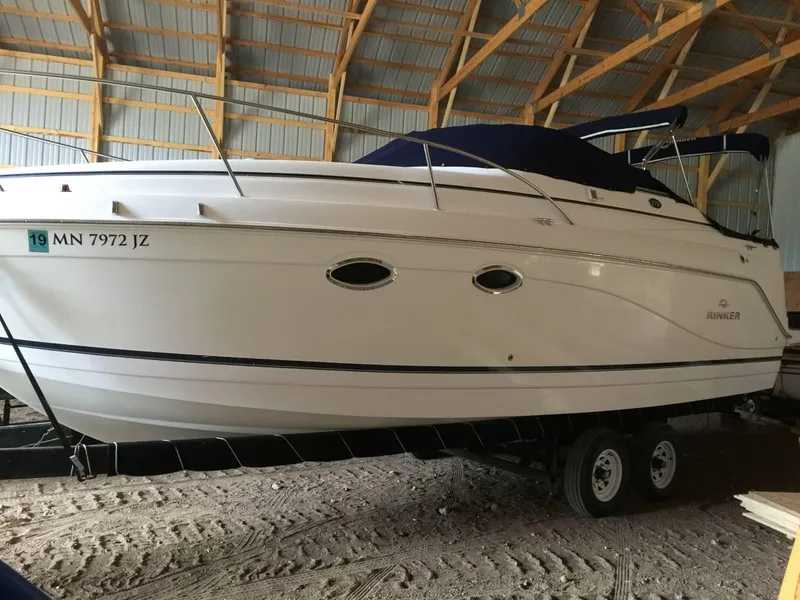 Slide: The Image of 2006 Rinker 270 Express Cruiser stored in a barn. - 10