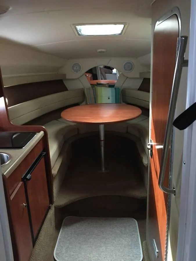 Slide: The Image of Interior of 2006 Rinker 270 Express Cruiser with table and seating area. - 15