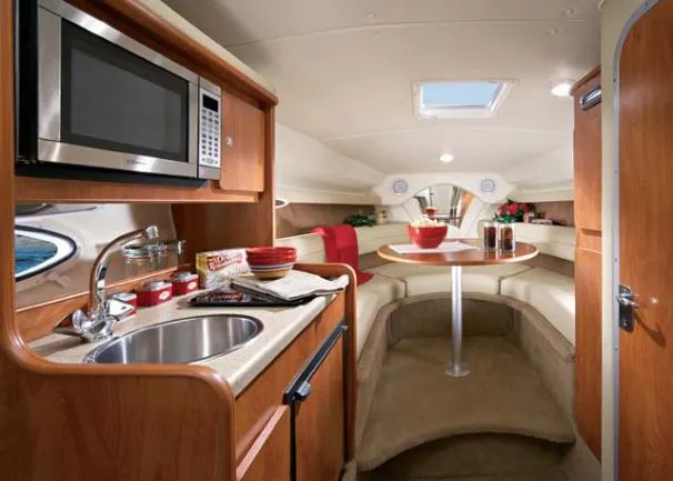 Slide: The Image of Interior of 2006 Rinker 270 Express Cruiser with kitchen and dining area. - 18