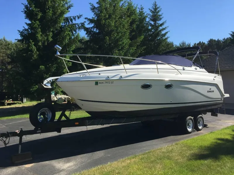 Slide: The Image of 2006 Rinker 270 Express Cruiser on trailer outdoors. - 2