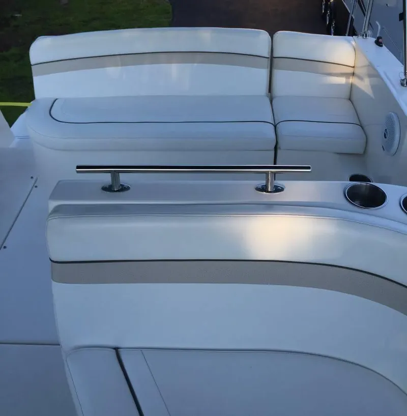 Slide: The Image of 2006 Rinker 270 Express Cruiser seating area with white upholstery. - 4