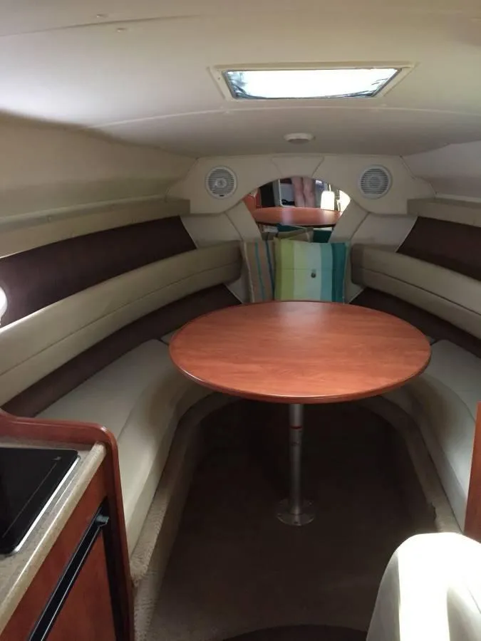 Slide: The Image of Interior of 2006 Rinker 270 Express Cruiser with table and seating area. - 5