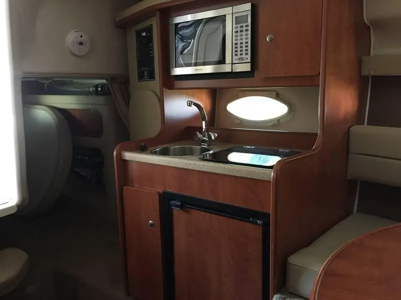 Slide: The Image of Interior of 2006 Rinker 270 Express Cruiser with kitchenette. - 8