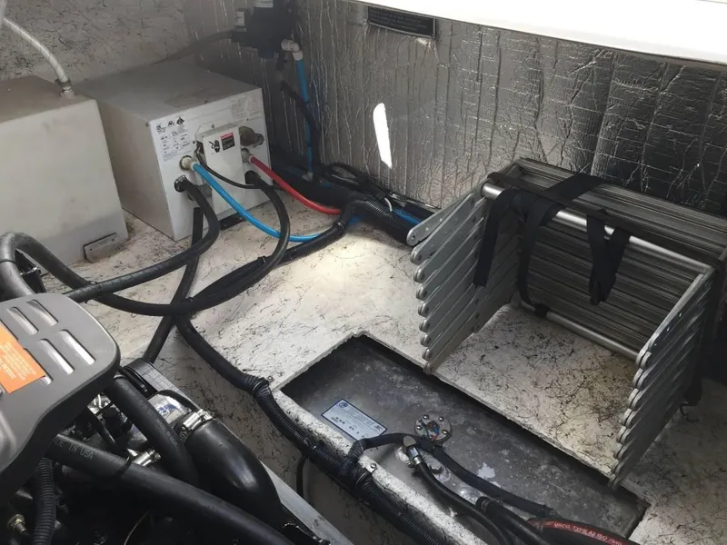 Slide: The Image of Engine compartment of 2006 Rinker 270 Express Cruiser with cables and equipment. - 9