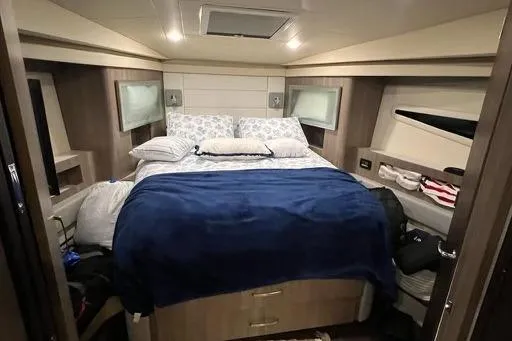 Slide: The Image of Luxurious cabin interior of 2022 Regal 42 XO yacht with cozy bedding. - 10