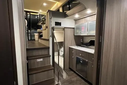 Slide: The Image of Luxurious interior of 2022 Regal 42 XO yacht featuring modern kitchen and cozy living space. - 11
