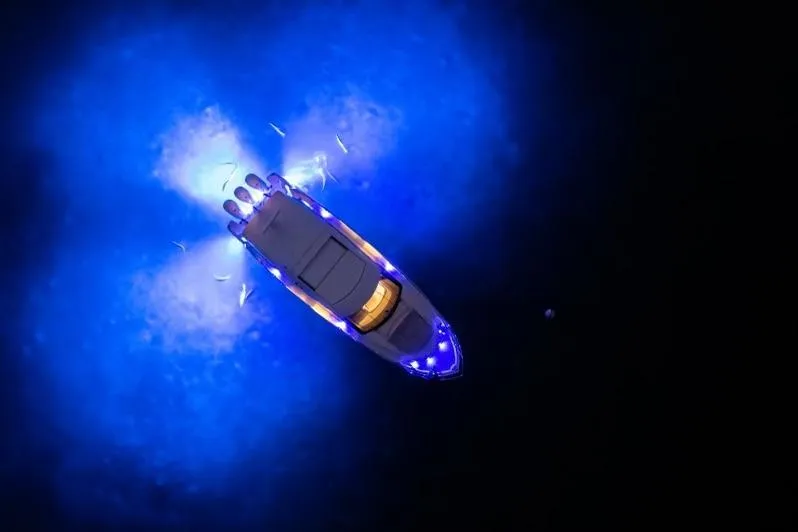 Slide: The Image of Aerial view of 2022 Regal 42 XO yacht illuminated with blue lights at night. - 14
