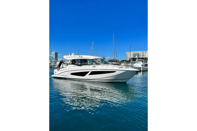Slide: The Image of 2022 Regal 42 XO yacht in marina, clear blue sky, calm water. - 2