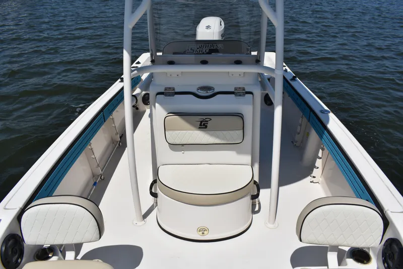 Slide: The Image of 2022 Carolina Skiff 21 Ultra Elite boat interior with seating, on calm water. - 12