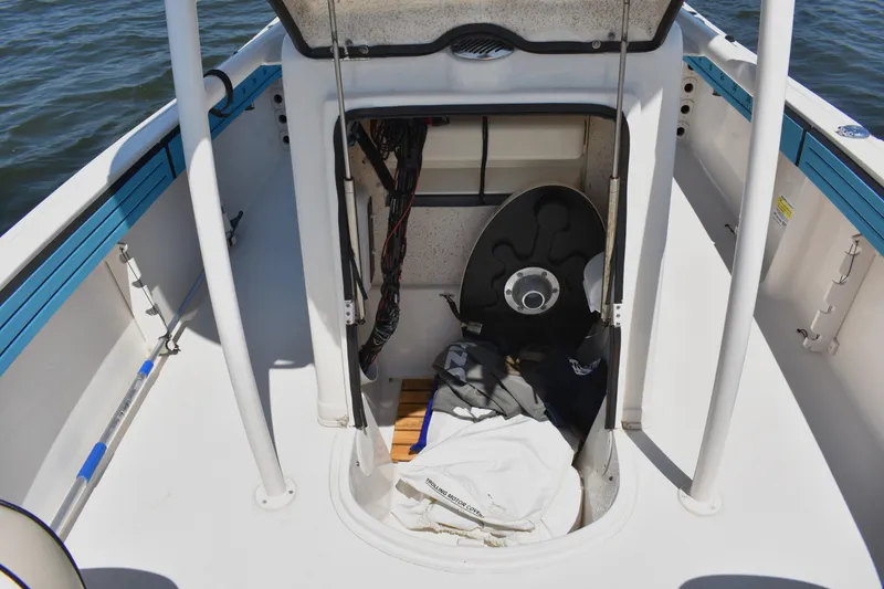 Slide: The Image of 2022 Carolina Skiff 21 Ultra Elite boat storage compartment with equipment and gear. - 13