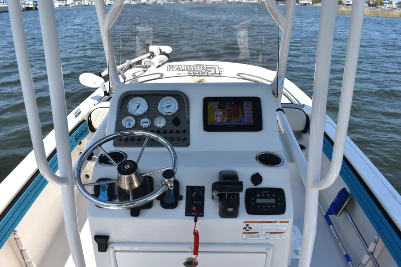 Slide: The Image of 2022 Carolina Skiff 21 Ultra Elite boat dashboard with steering wheel and navigation instruments. - 14