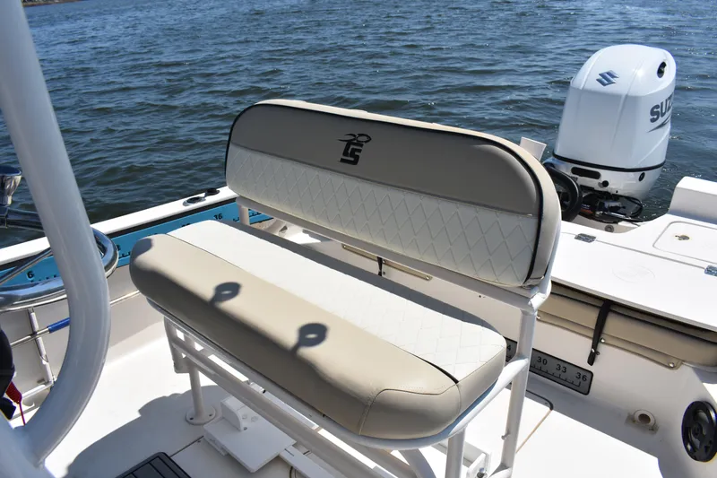 Slide: The Image of 2022 Carolina Skiff 21 Ultra Elite boat interior with seating and Suzuki outboard motor. - 15