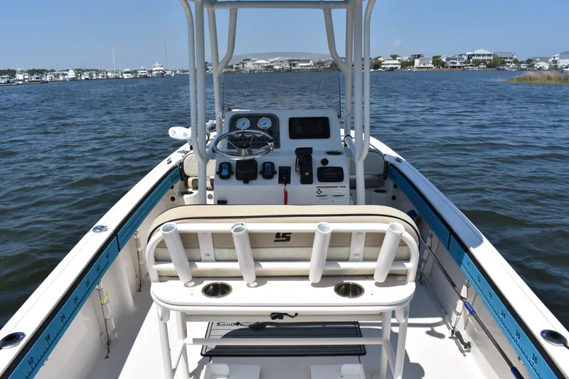 Slide: The Image of 2022 Carolina Skiff 21 Ultra Elite boat interior with steering console on calm water. - 16
