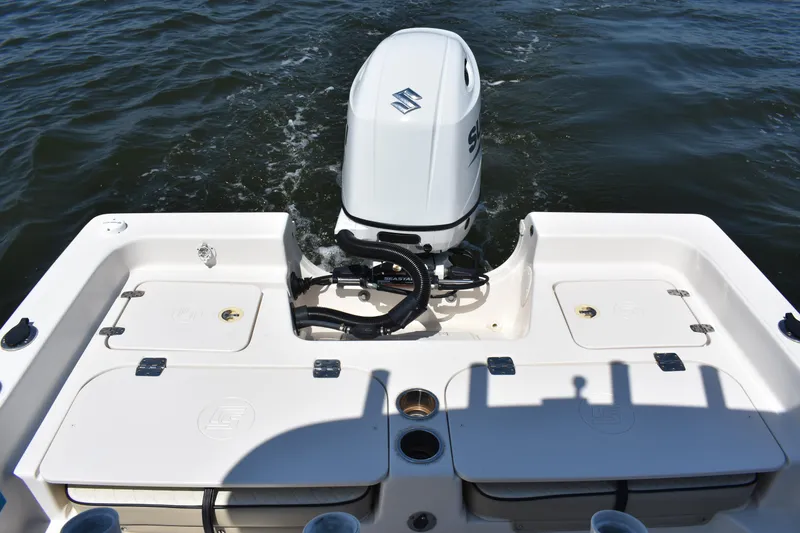 Slide: The Image of 2022 Carolina Skiff 21 Ultra Elite boat with Suzuki outboard motor on water. - 18