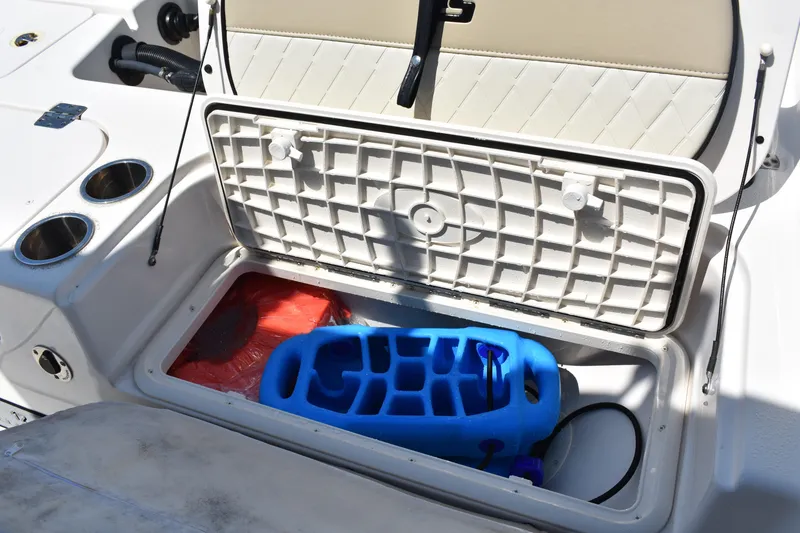 Slide: The Image of Open storage compartment on 2022 Carolina Skiff 21 Ultra Elite boat with accessories inside. - 21