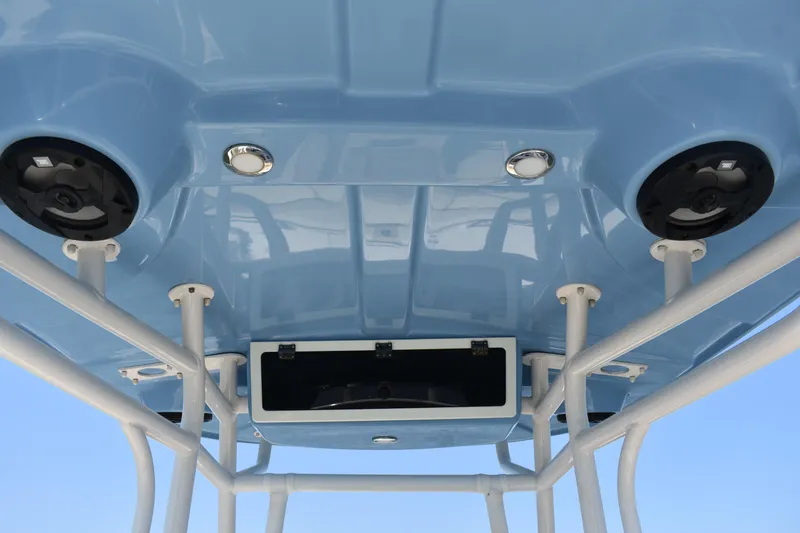 Slide: The Image of 2022 Carolina Skiff 21 Ultra Elite boat T-top with speakers and storage compartment. - 23