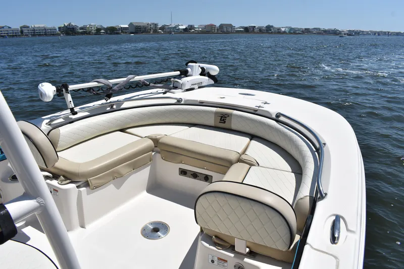 Slide: The Image of 2022 Carolina Skiff 21 Ultra Elite boat with cushioned seating on calm water. - 7