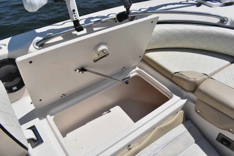 Slide: The Image of 2022 Carolina Skiff 21 Ultra Elite boat storage compartment open on deck. - 9