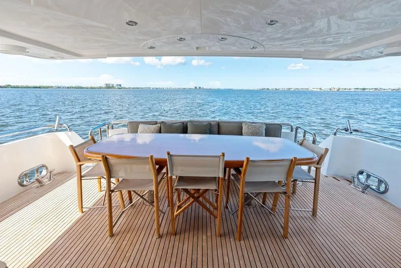 Slide: The Image of Luxury yacht deck with dining table, chairs, and ocean view, Horizon 82, 2005 model. - 11