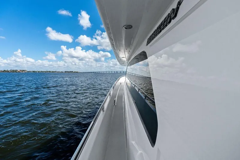 Slide: The Image of Side view of 2005 Horizon 82 yacht cruising on open water under blue sky. - 12