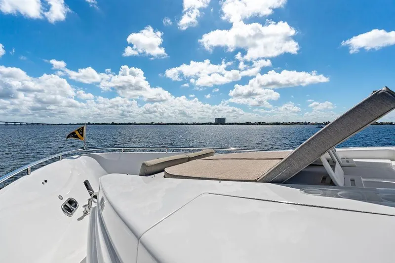 Slide: The Image of Luxury Horizon 82 yacht deck with sunbed, overlooking serene ocean and blue sky, 2005 model. - 13