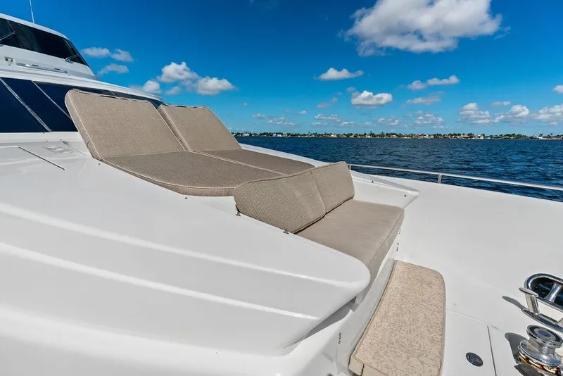 Slide: The Image of Luxurious 2005 Horizon 82 yacht with sun loungers on deck, cruising under a clear blue sky. - 14