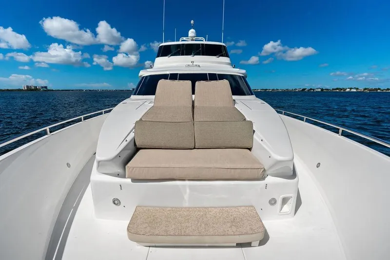 Slide: The Image of Luxurious Horizon 82 yacht deck with cushioned seating, cruising on a sunny day, 2005 model. - 16