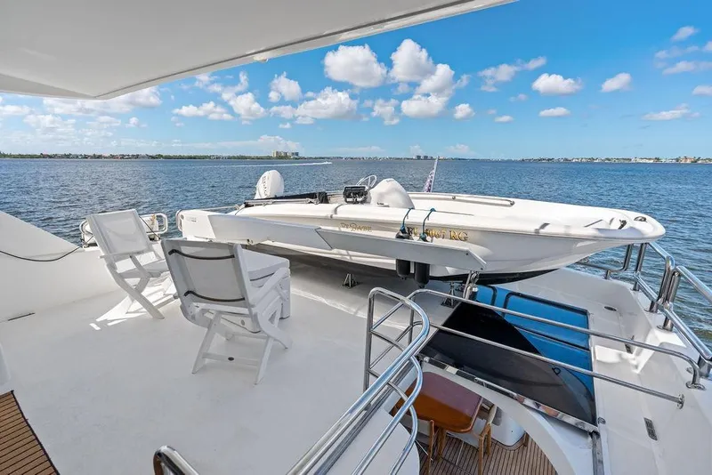 Slide: The Image of Luxury Horizon 82 yacht deck with seating and small boat, 2005 model, ocean view. - 18