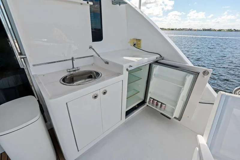 Slide: The Image of Outdoor yacht kitchenette with sink and open mini-fridge, Horizon 82, 2005 model, ocean view. - 19