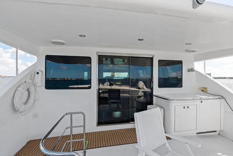 Slide: The Image of Luxury yacht deck with seating, cabinets, and ocean view, Horizon 82 model, 2005. - 21