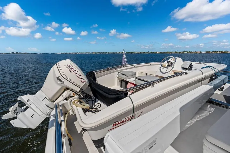 Slide: The Image of A 2005 Horizon 82 boat with Evinrude motor on a calm sea under blue skies. - 22